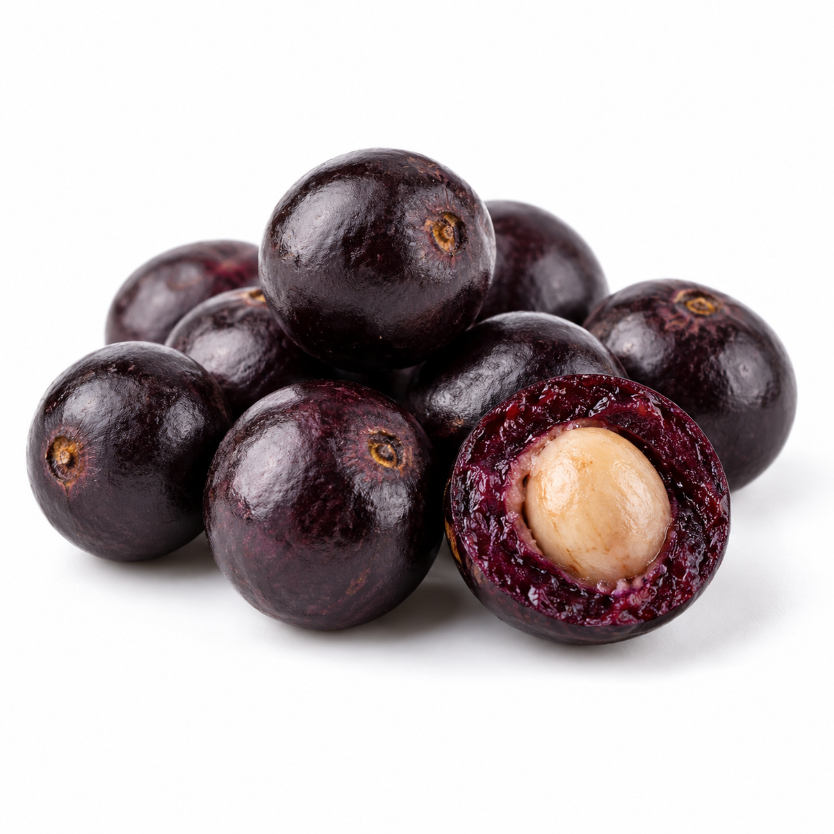 Acai berries and an opened fruit showing the dark flesh around its large seed, on a white background.